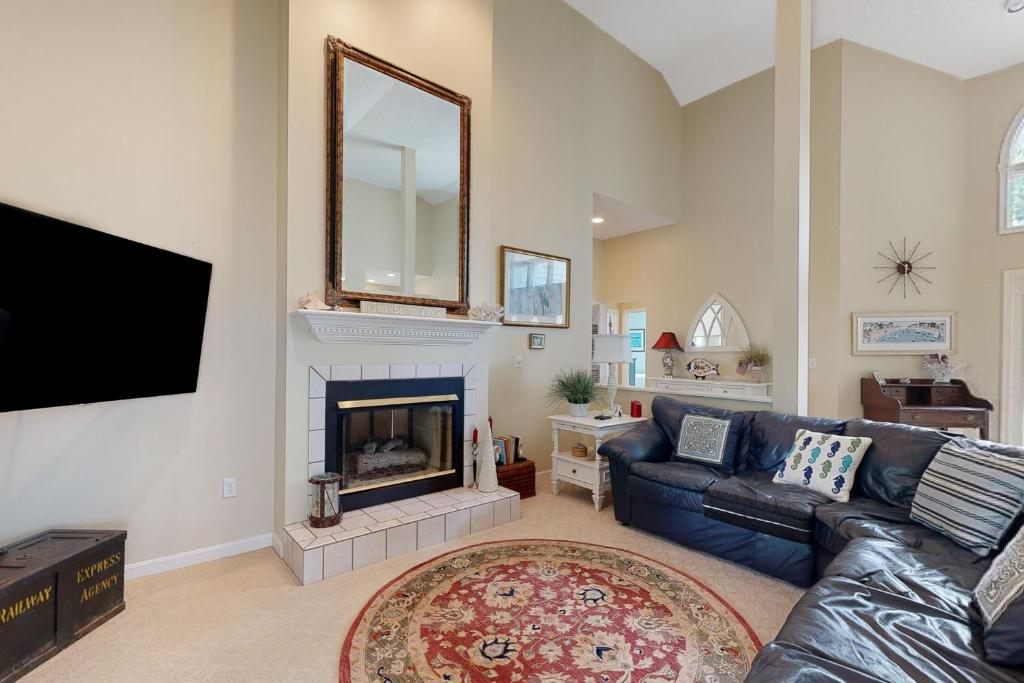 a living room with a couch and a fireplace at Salt Pond --- 314 Walkabout Rd in Bethany Beach