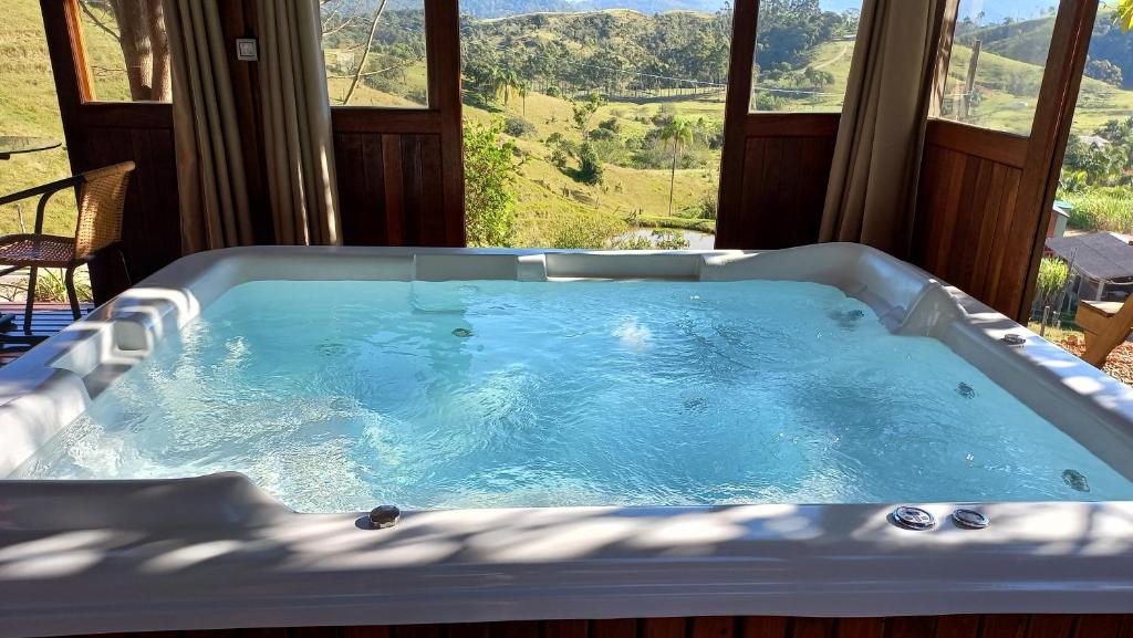 a jacuzzi tub in a room with a view at CABANA PARAÍSO in Santo Amaro da Imperatriz