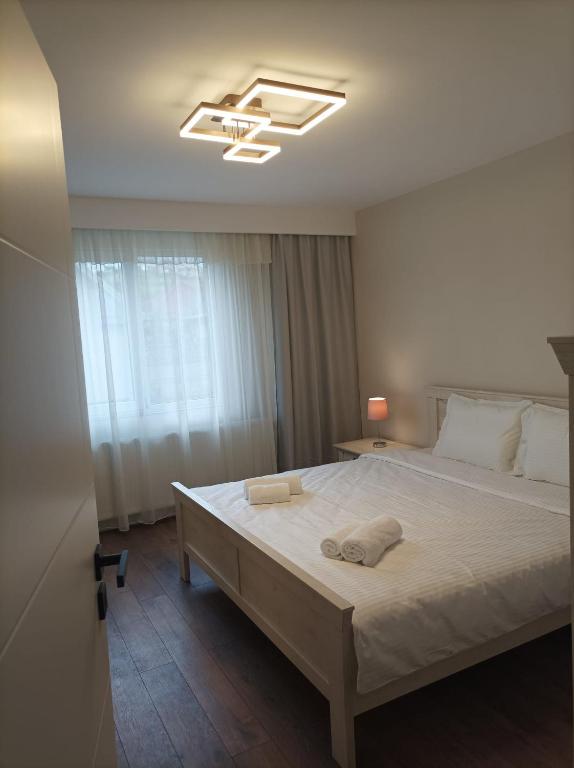 a bedroom with a large bed with a ceiling at Casa Jisa in Turda
