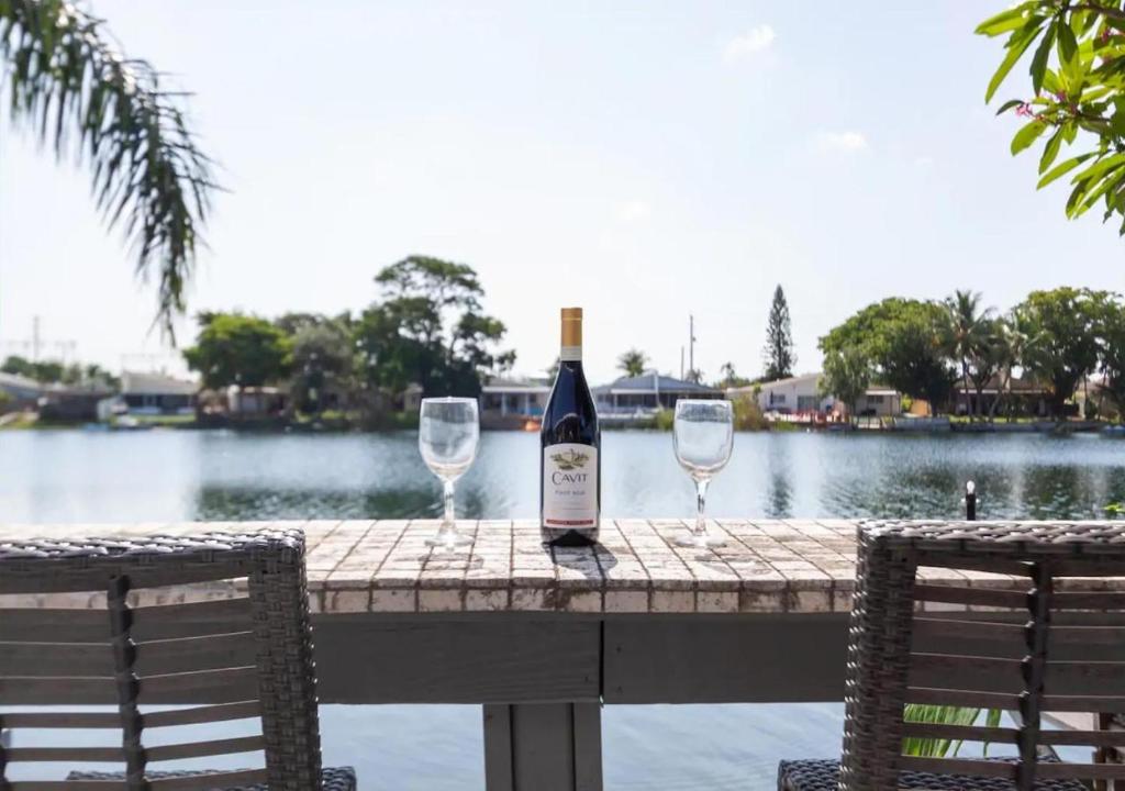 a bottle of wine sitting on a table with two wine glasses at The Lake House in Fort Lauderdale in Fort Lauderdale