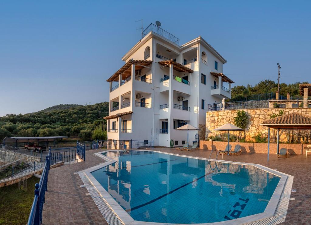 a hotel with a swimming pool in front of a building at Villa Rodanthi Sivota in Syvota
