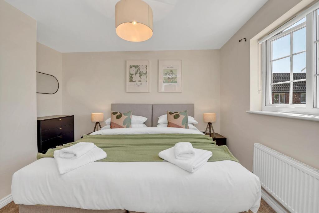 a bedroom with a large white bed with pillows at The Grange Luxe2 in Ipswich