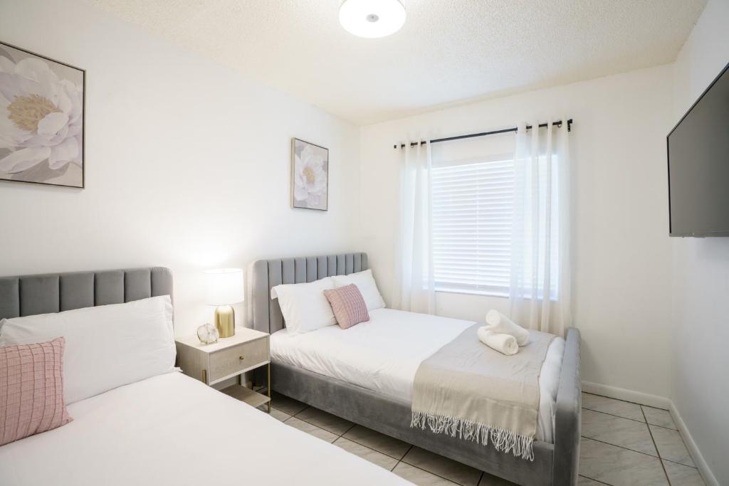 1 dormitorio con 2 camas y ventana en Modern 2 Bedroom in the Heart of Wynwood Art District, en Miami