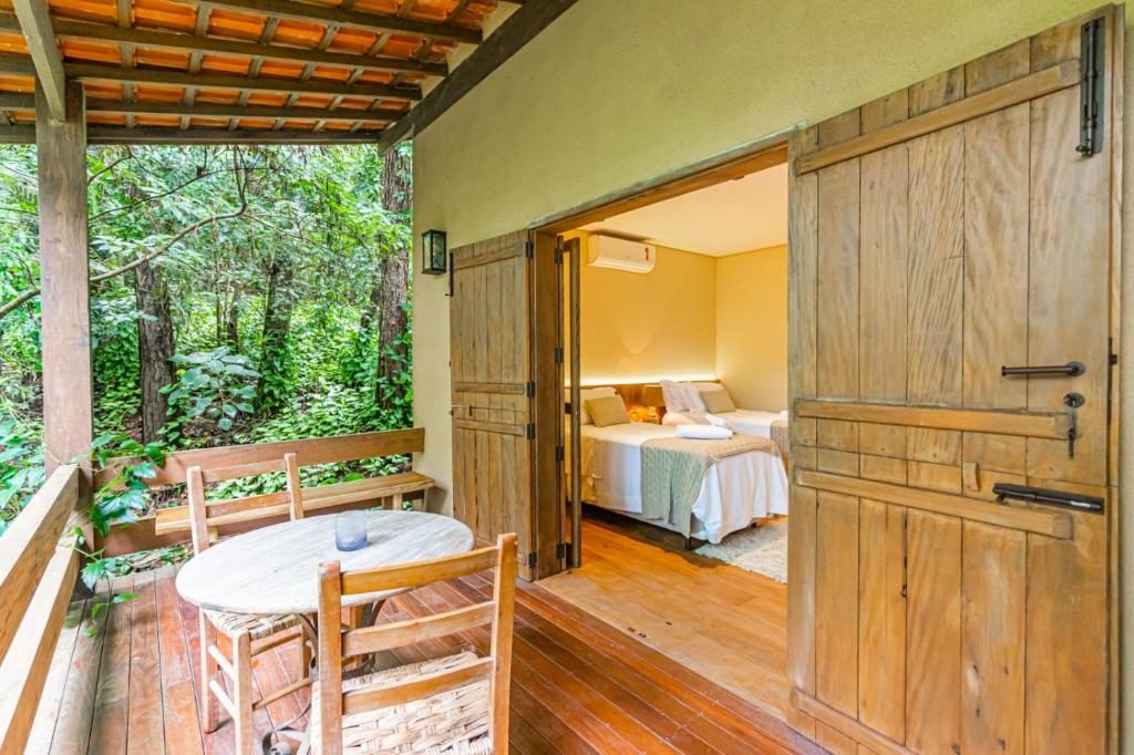 a room with a bedroom and a bed and a door at Villa Tanah in São Roque