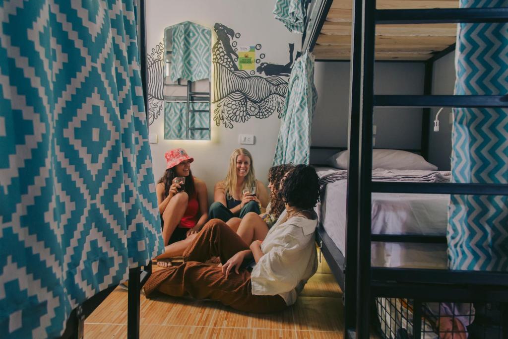 three girls sitting on the floor of a bunk bed at Rafiki Hostels - Dahab in Dahab