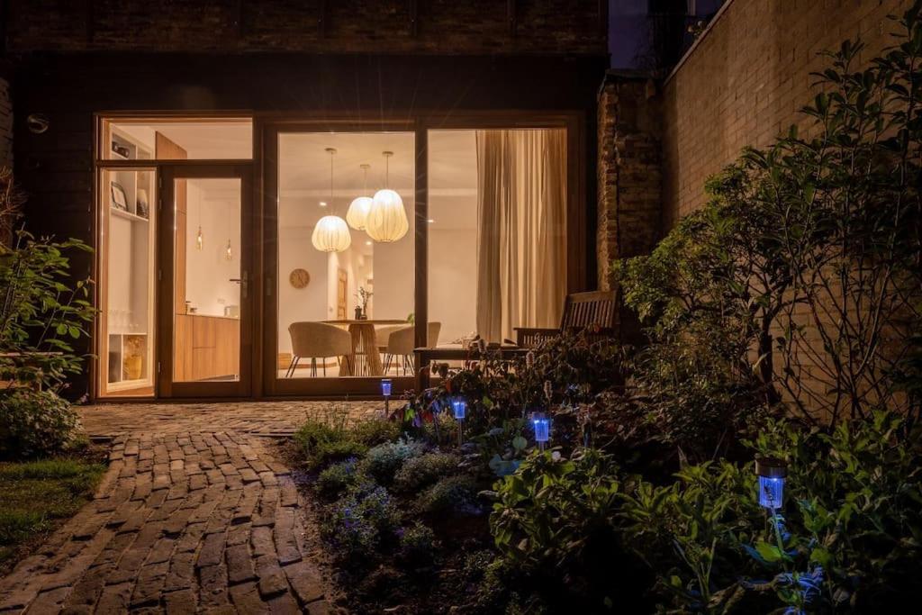 a front door of a house at night with lights at Appartement met tuin in Haarlem centrum(Vijfhoek) in Haarlem