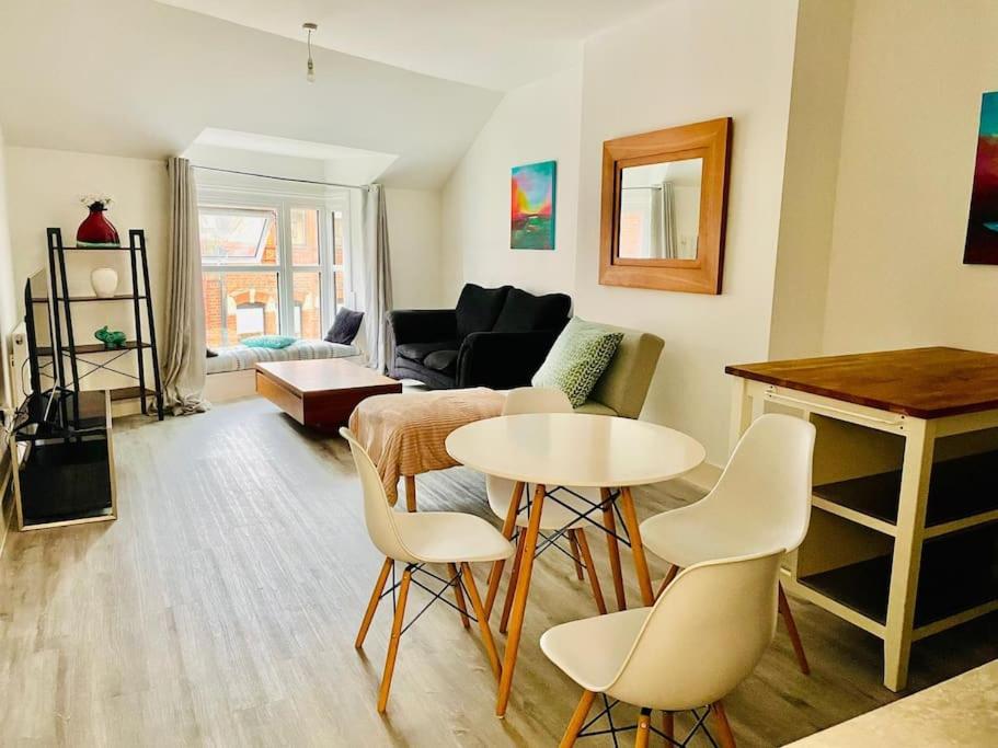 a living room with a table and chairs at Central modern 1 Bed 1 Bath flat in Woking