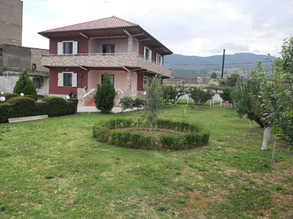 a house with a garden in front of it at Liora's Vila in Laç