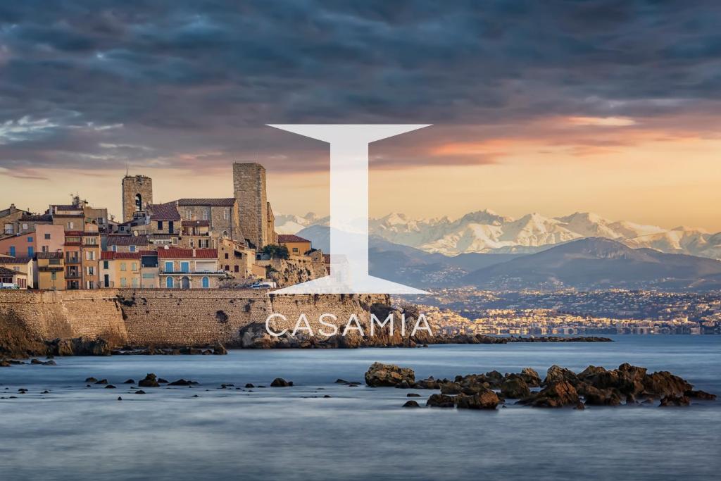 a city with a white cross on top of a city at Fisherman House by iCasamia in Antibes