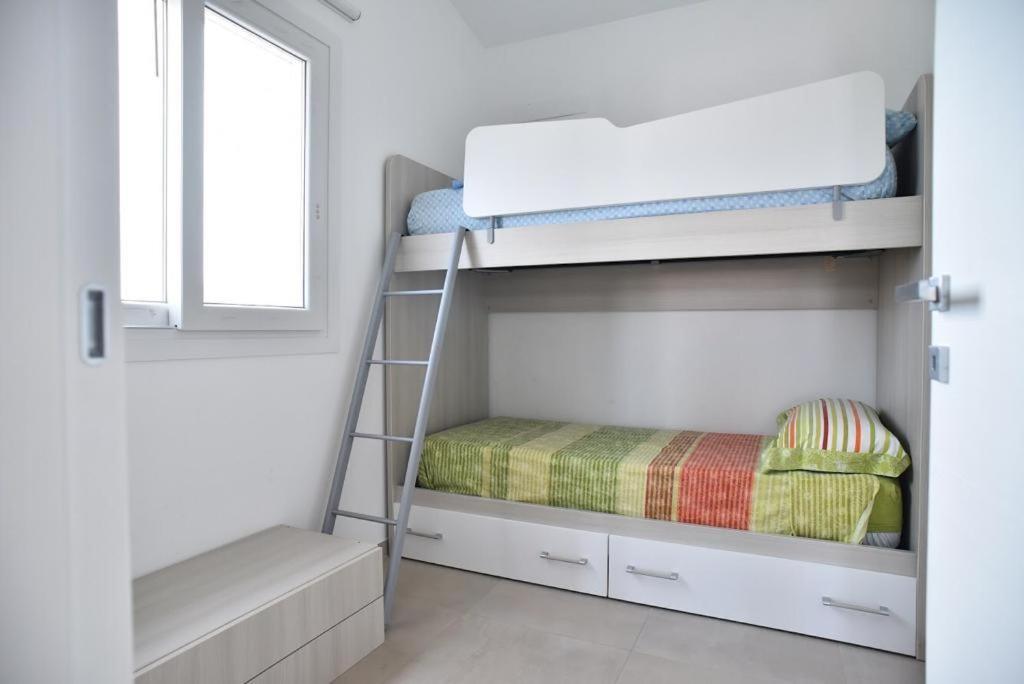 Postel nebo postele na pokoji v ubytování Appartamento Oasi con Piscina
