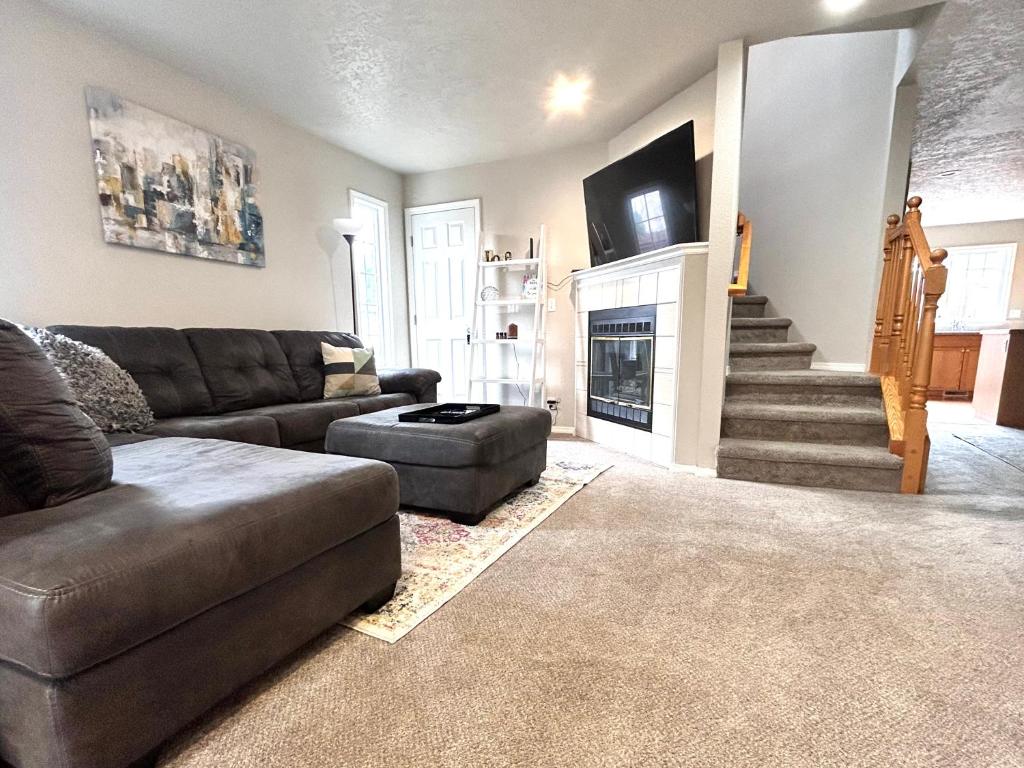 a living room with a couch and a fireplace at The Getaway SE Boise Condo Across the street from Greenbelt, Bown Crossing and Boise River 3BD 3Bath, 4 beds! Lovely, Homey, Dining table seats 6 in Boise