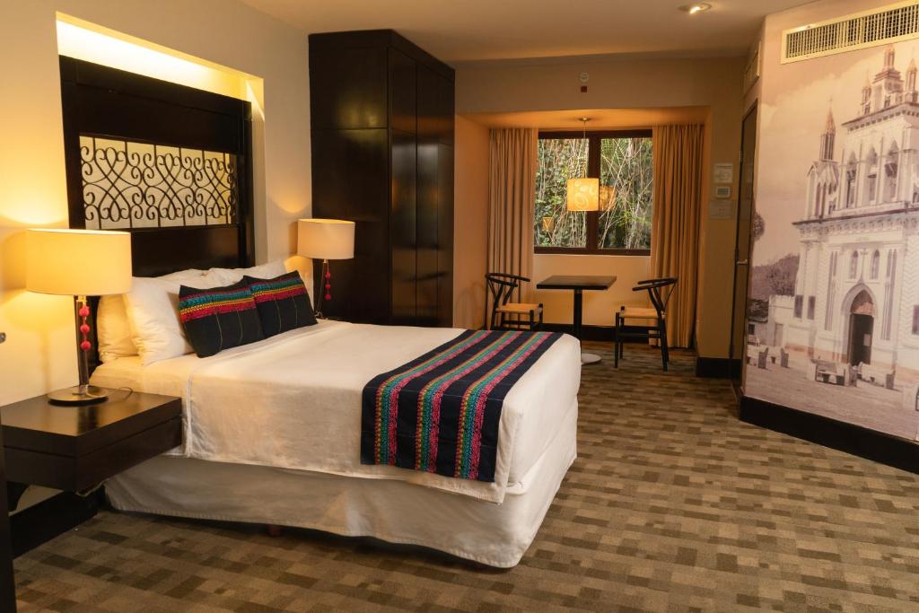a hotel room with a large bed and a television at Casa del Alma Hotel Boutique & Spa in San Cristóbal de Las Casas