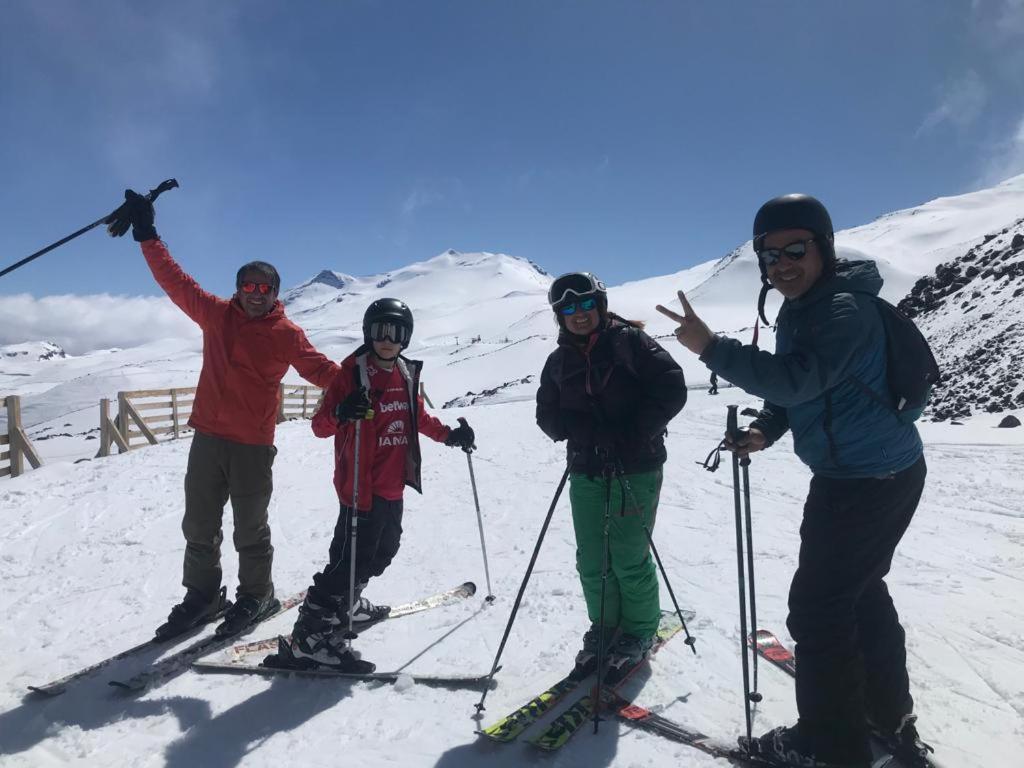 a group of people on skis in the snow at Nevados de chillan , edificio los coigues in Nevados de Chillan