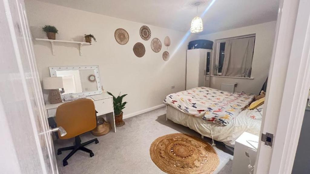 a bedroom with a bed and a desk and a chair at semi-detached houses in Manchester