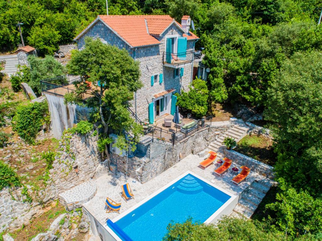 an aerial view of a house with a swimming pool at Villa Toscana in Tivat
