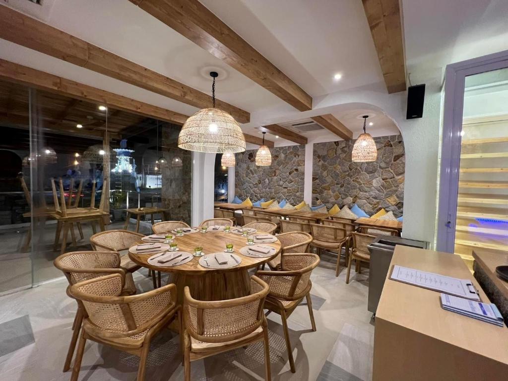 a dining room with a table and chairs at Coral Inn in Karon Beach