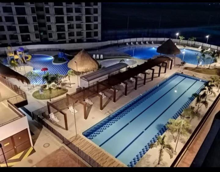 a view of a swimming pool at a resort at night at Apartamento en Condomio Peñazul La Aldea en Ricaurte - Girardot in Ricaurte