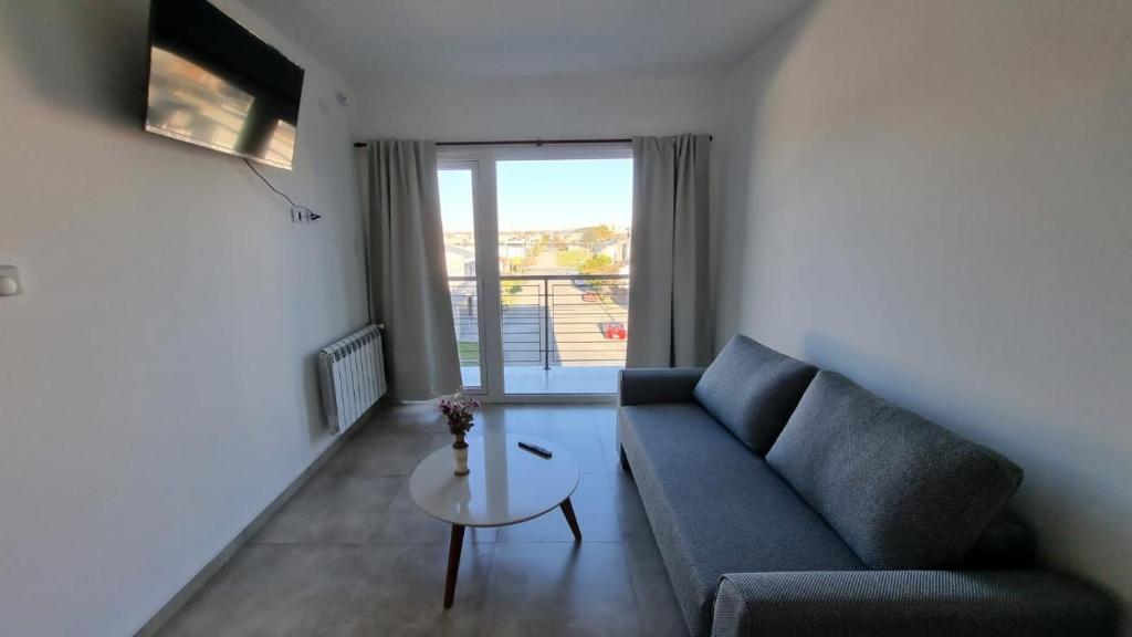 a living room with a couch and a table at Departamento Rivadavia in Olavarría
