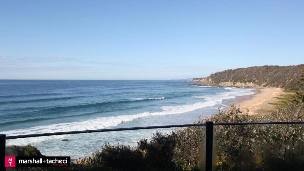 a view of a beach with the ocean at Bermagui bliss beachfront holiday house in Bermagui
