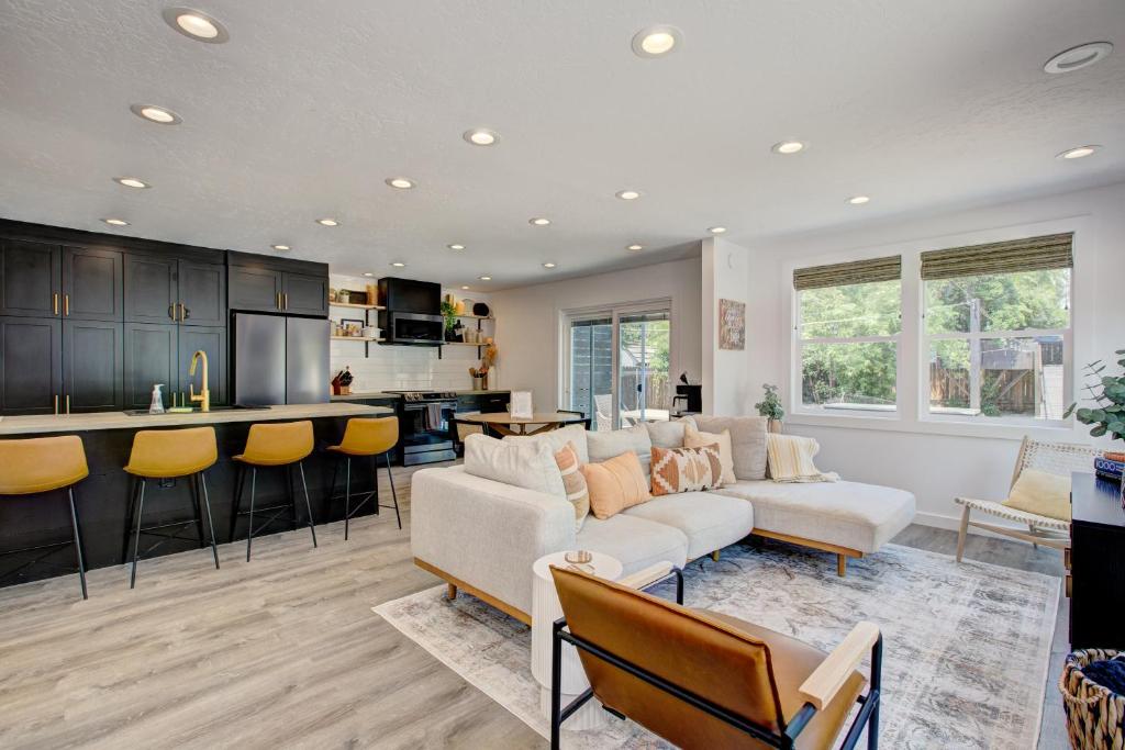 a living room with a couch and a kitchen at Off-Broadway - Modern woutdoor haven in Boise