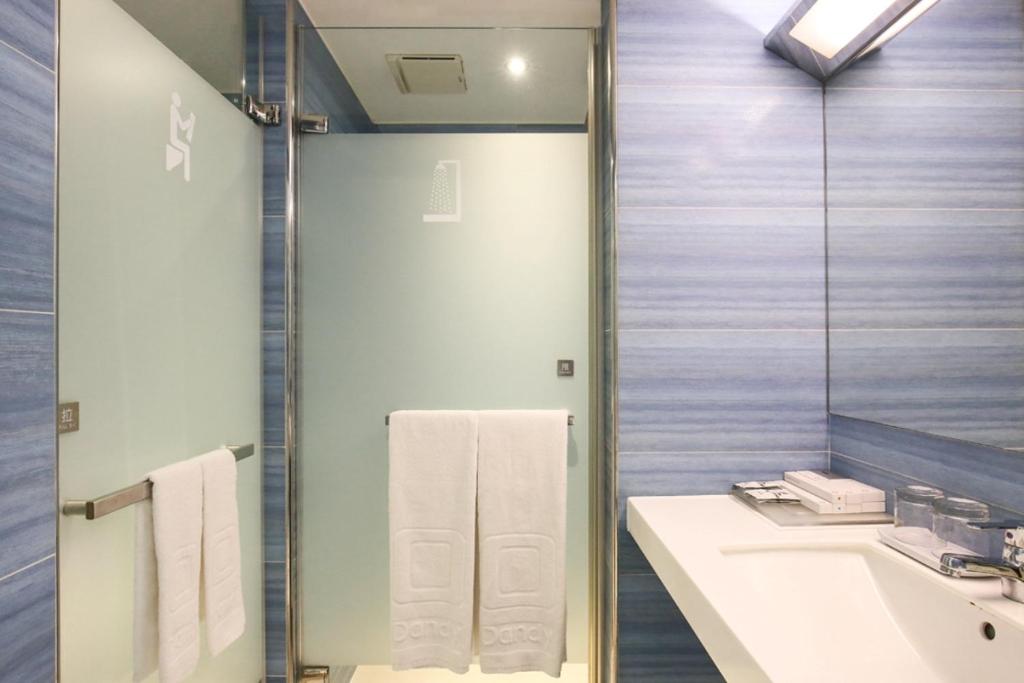 a bathroom with a sink and a mirror at Dandy Hotel - Tianmu Branch in Taipei