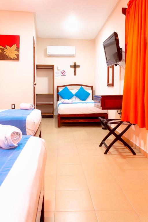 Postel nebo postele na pokoji v ubytování Hotel Bacalar Magico