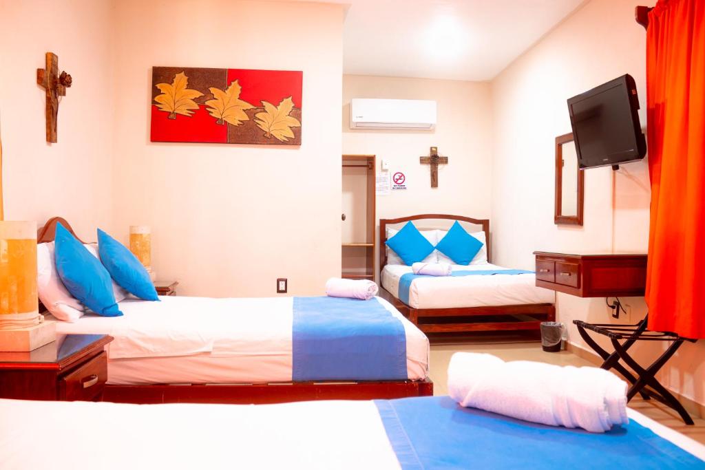 Postel nebo postele na pokoji v ubytování Hotel Bacalar Magico
