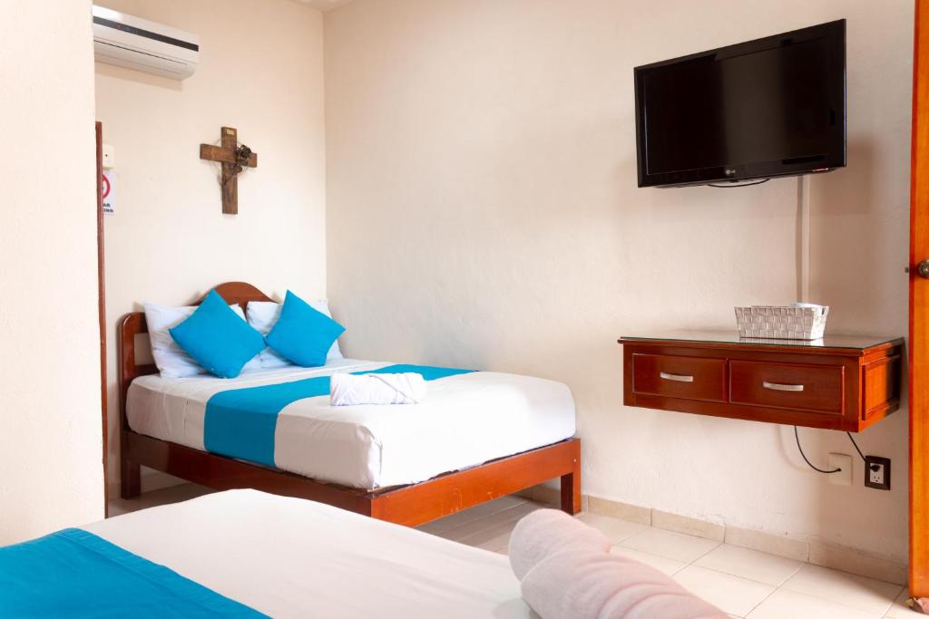 Postel nebo postele na pokoji v ubytování Hotel Bacalar Magico