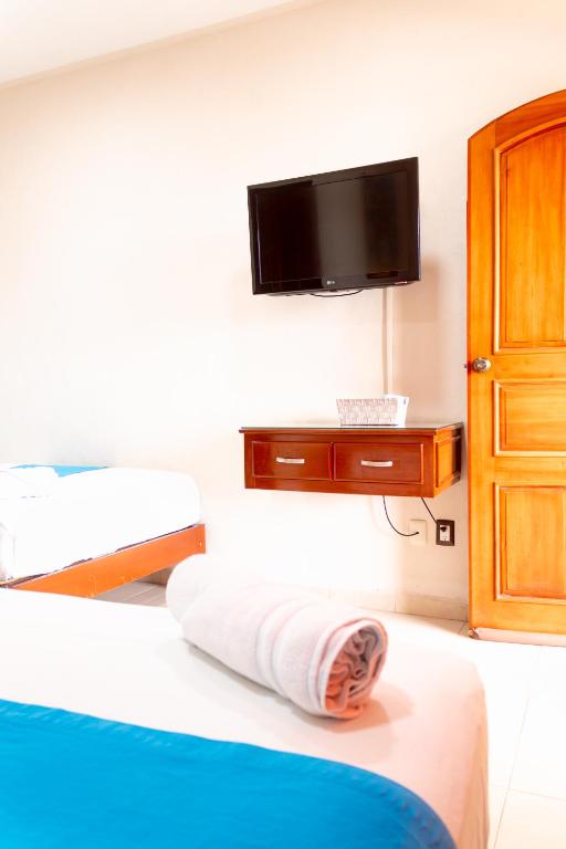 Postel nebo postele na pokoji v ubytování Hotel Bacalar Magico