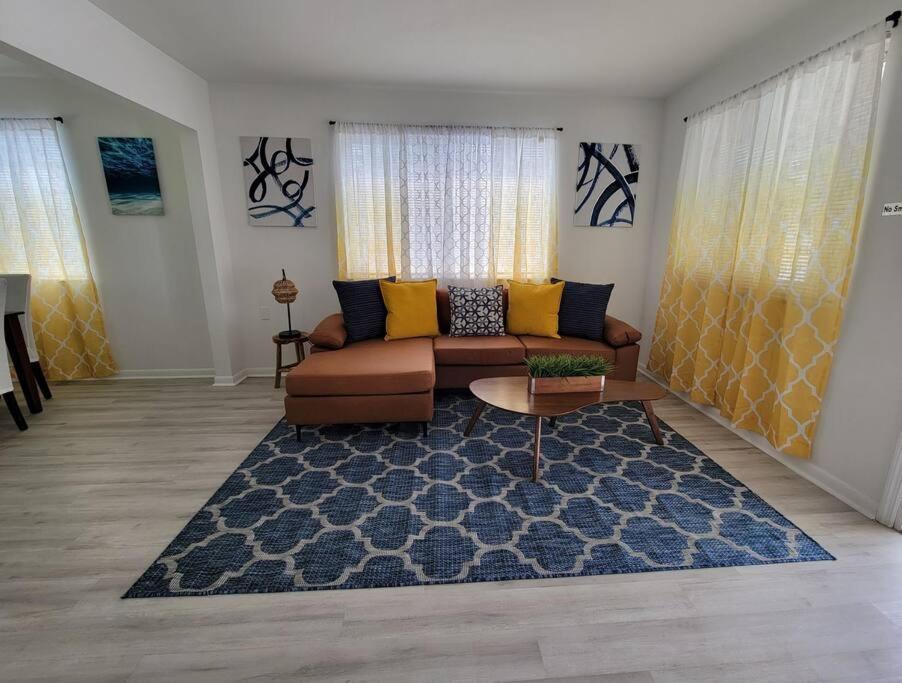 a living room with a couch and a rug at Sol Miami # 2 with free parking in Miami