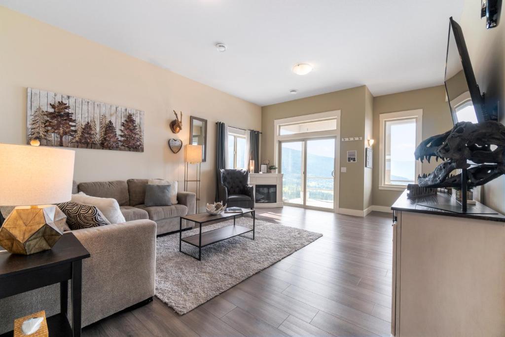 a living room with a couch and a table at Oh What A View! - Lower Suite in Vernon