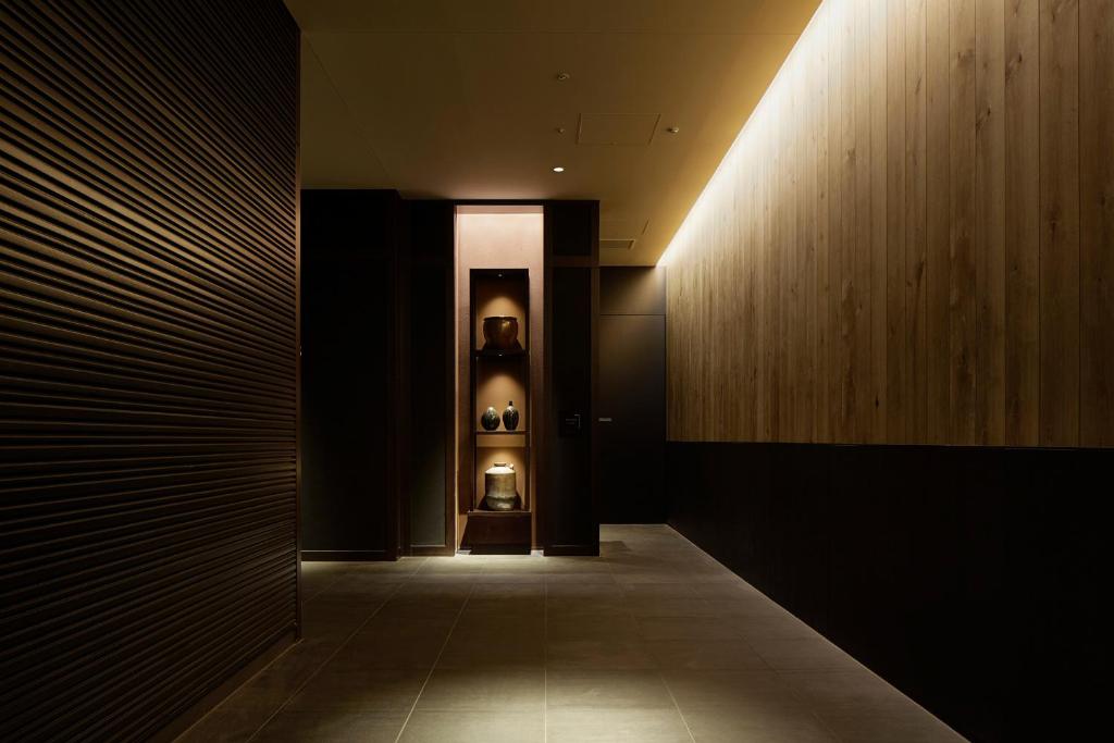 a hallway with a lighted wall and a hallway with at Hotel Gracery Shinjuku in Tokyo
