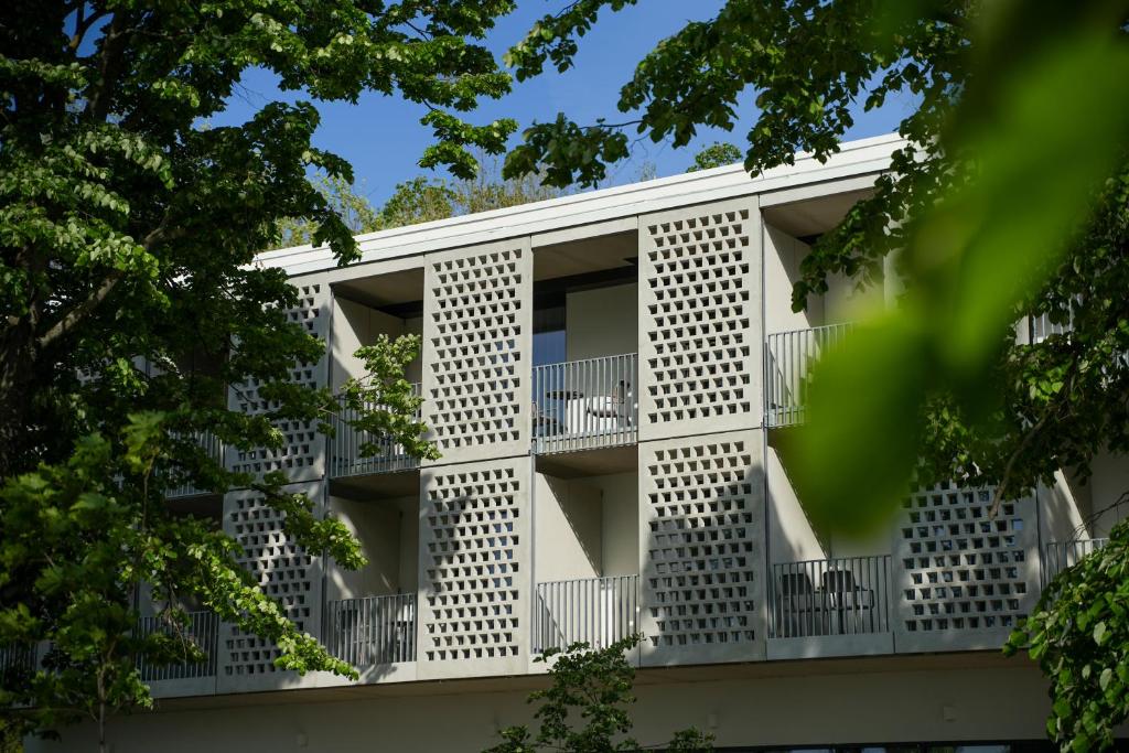 an apartment building with balconies and trees at LUA Boutique RoomZ- Adults only in Balatonfüred