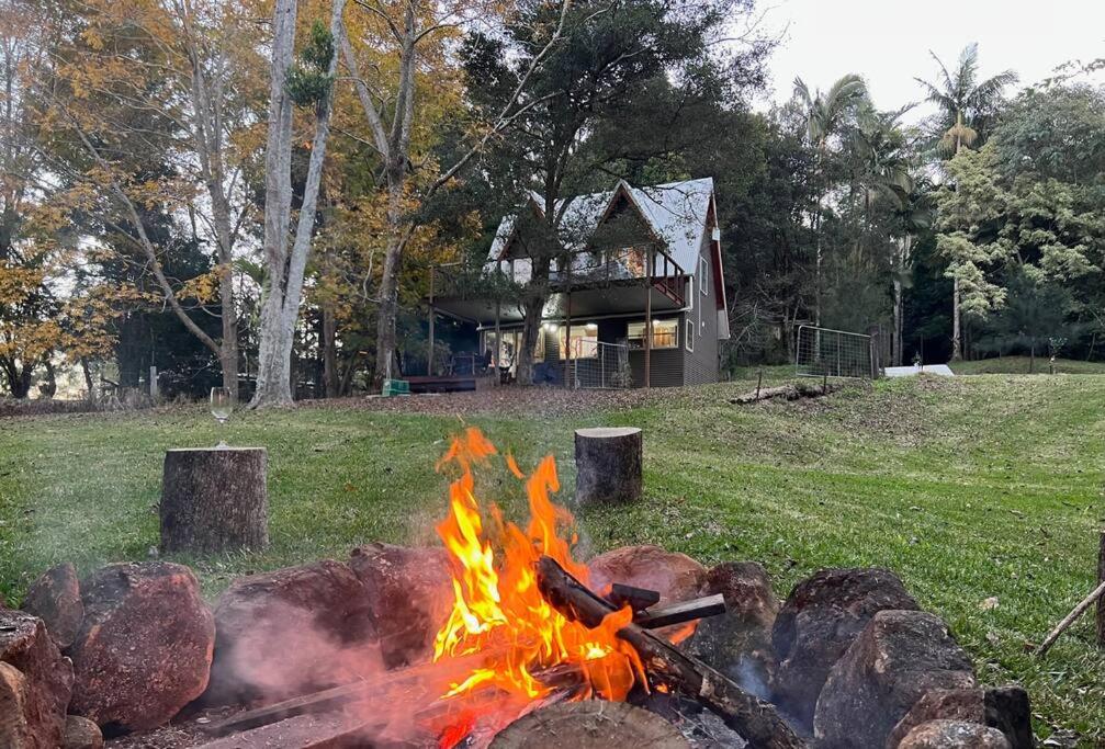 a fire pit in front of a house at Winding Creek Cottage in Bald Knob