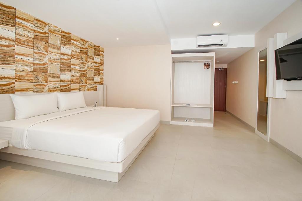 Postel nebo postele na pokoji v ubytování Dafam Resort Belitung