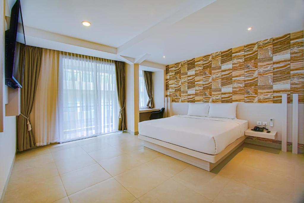 Postel nebo postele na pokoji v ubytování Dafam Resort Belitung