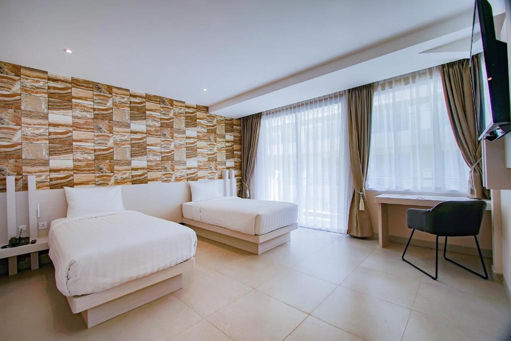 Postel nebo postele na pokoji v ubytování Dafam Resort Belitung