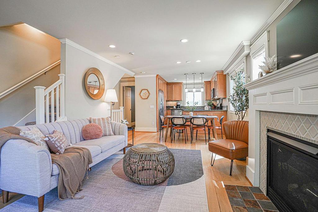 a living room with a couch and a fireplace at Exquisite Central Townhome with Spacious Loft and Gourmet Kitchen in Seattle