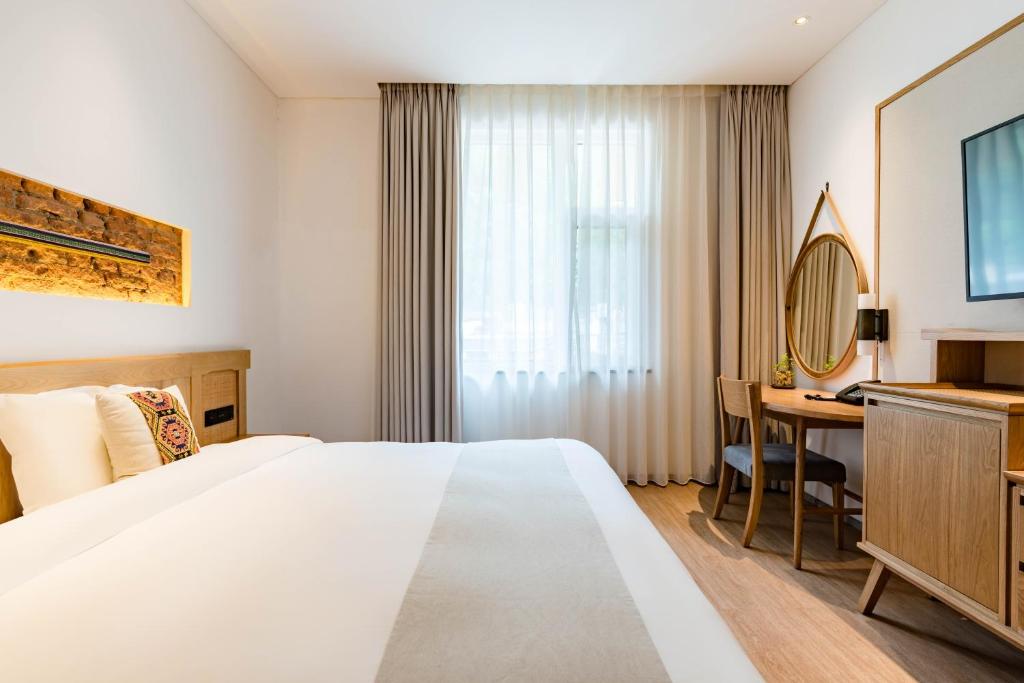 Postel nebo postele na pokoji v ubytování Yoba Boutique Hotel