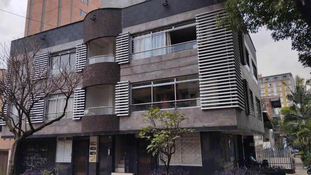 a building with wooden shutters on the windows of it at Apartamentos Florida Nueva estadio in Medellín