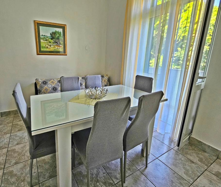 a dining room with a white table and chairs at Apartment Nina Marie in Split