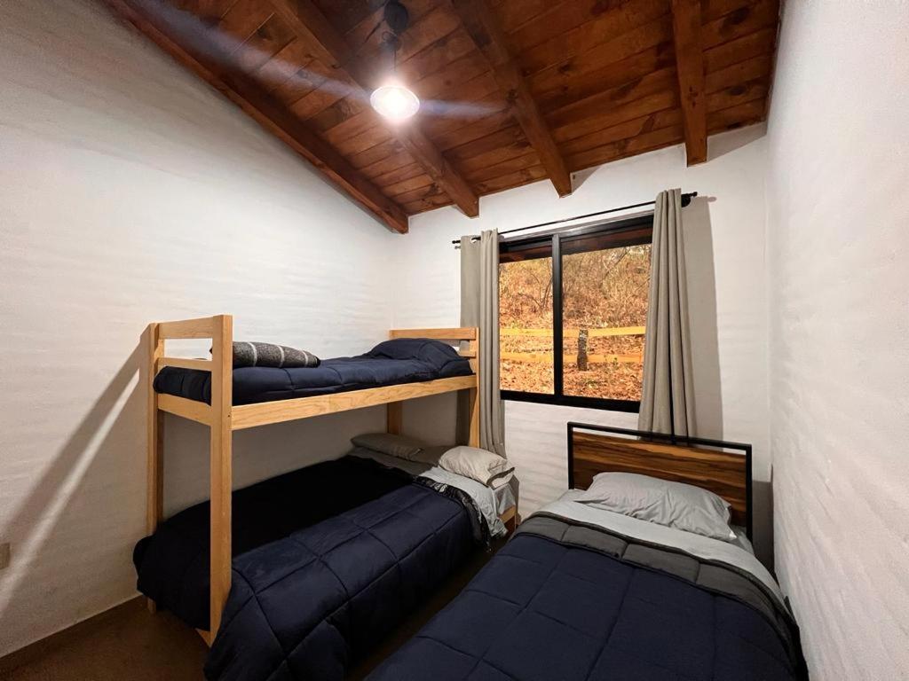Postel nebo postele na pokoji v ubytování Cabaña El Encanto
