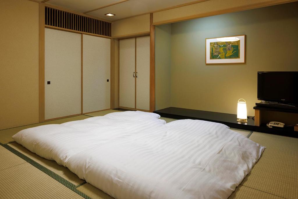 Postel nebo postele na pokoji v ubytování Yumoto Fujiya Hotel