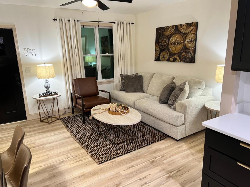 a living room with a couch and a table at Modern 2 Bedroom Apartment in Monroeville