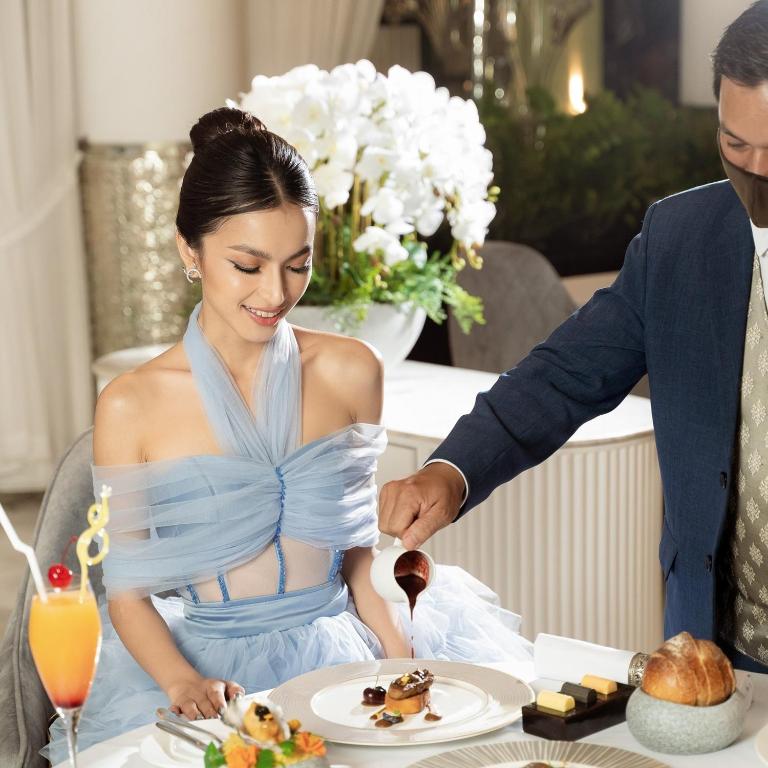 a bride and groom feeding each other food at a table at Borei Angkor Resort & Spa in Siem Reap