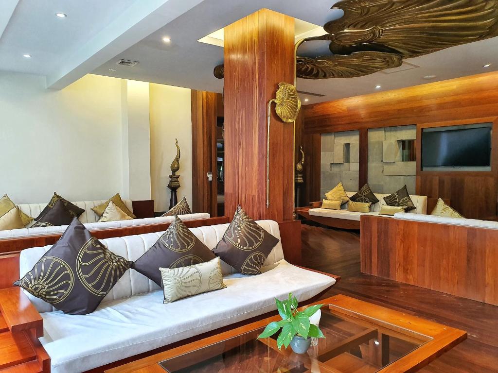 a living room with a couch and a tv at Borei Angkor Resort & Spa in Siem Reap