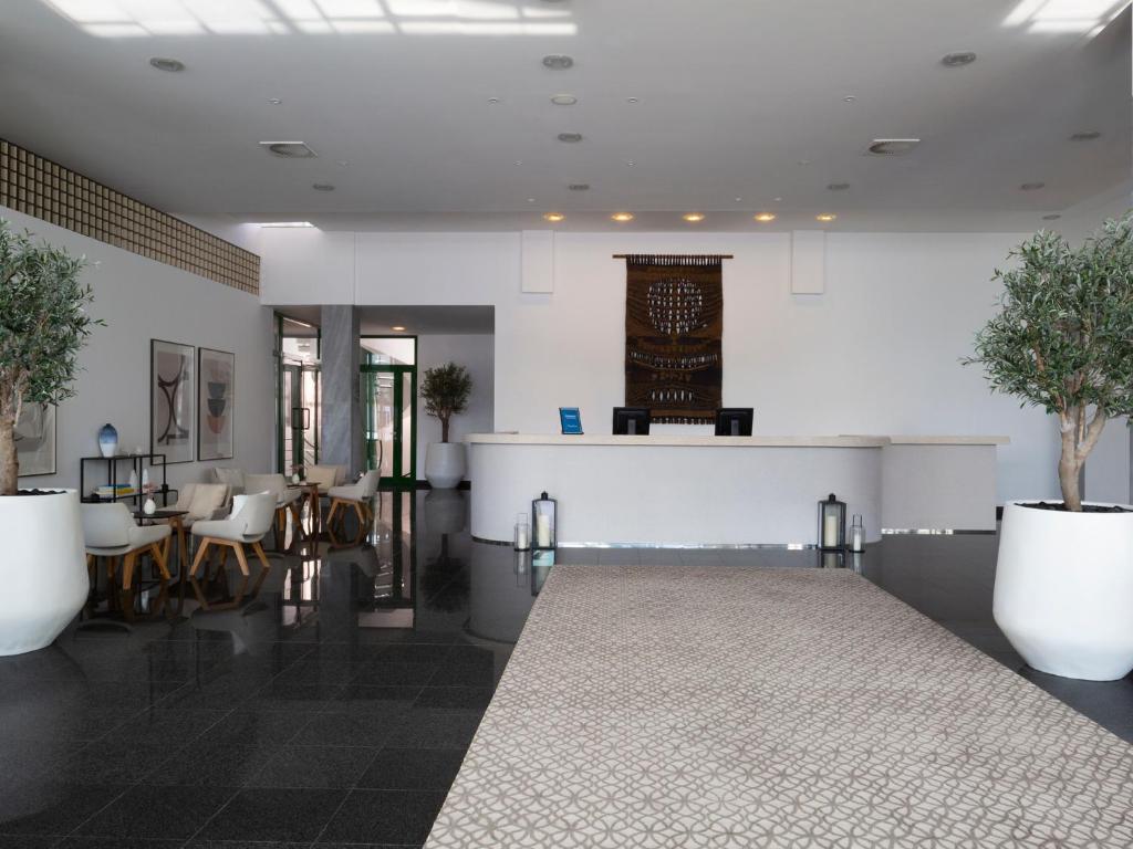 a lobby with a table and chairs and a counter at Bluesun Holiday Village Bonaca - Full Board Plus in Bol