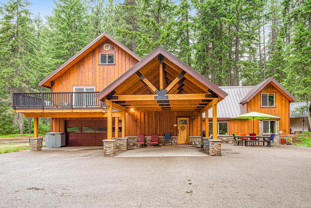 a large wooden cabin with a porch and a deck at Moose Lodge in Ronald