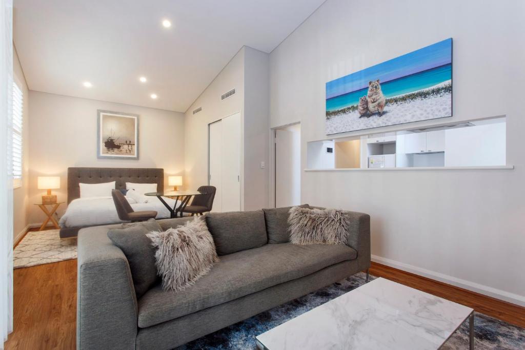 a living room with a couch and a bed at Luxury Modern Escapia in Fremantle