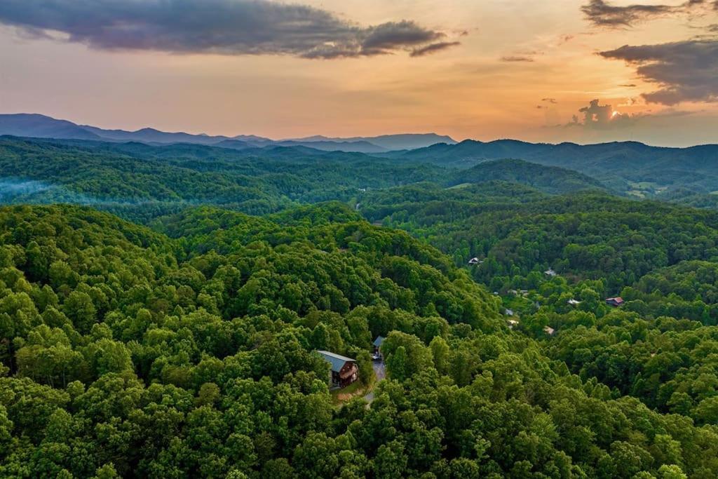 an aerial view of a forest of green trees at Panorama Mountain View Cabin, Less than 10 miles from Gatlinburg and Dollywood, Dog Friendly, 6 Bedrooms Sleeps 17, Fire Pit, HotTub, Washer Dryer, Fully loaded Kitchen, GameRoom with a TV, Pool Table, Arcade, Air Hockey, and Foosball in Sevierville